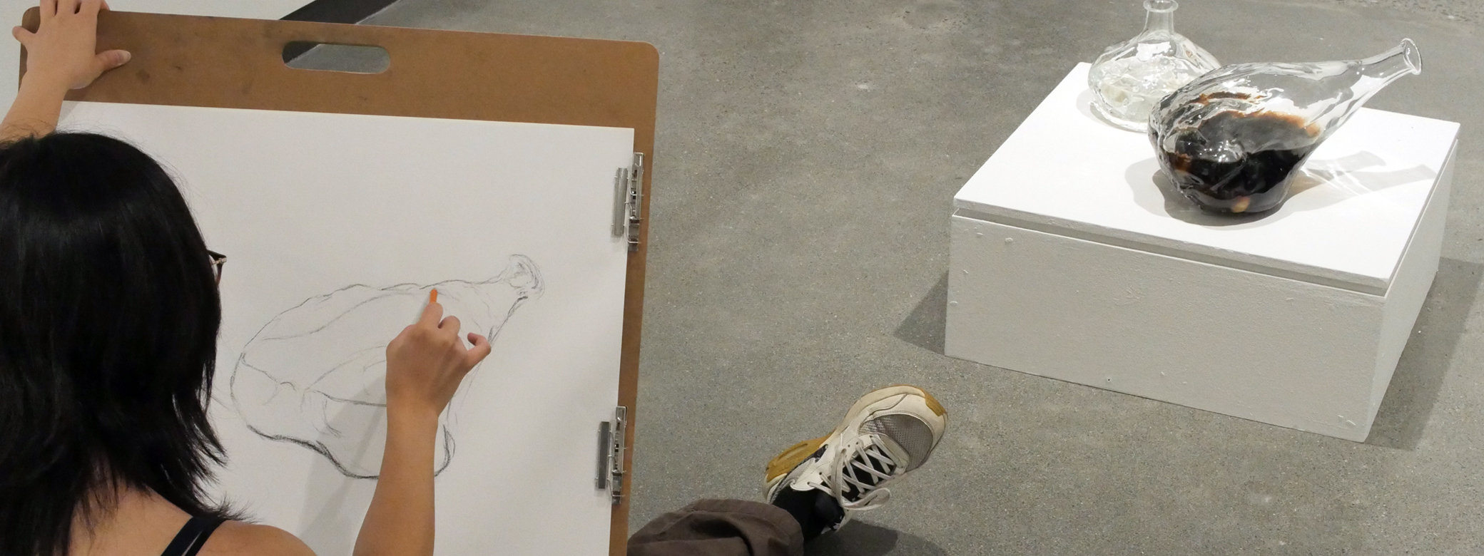 student drawing in gallery