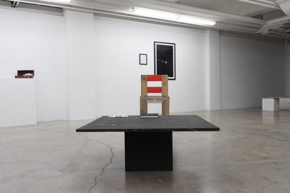 Exhibition view of a table and chair.