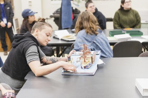 Veronica Markey looking at pop-up artist books in the UW Special Collections Library