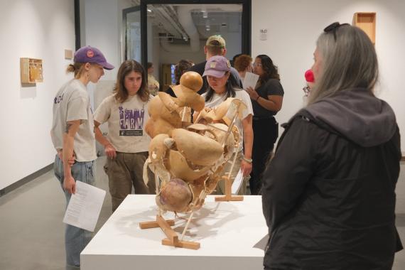 Students looking at Rob Rhee's work in the Jacob Lawrence Gallery