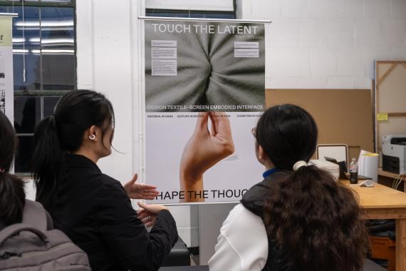 People viewing a Master of Design graduate student's work.
