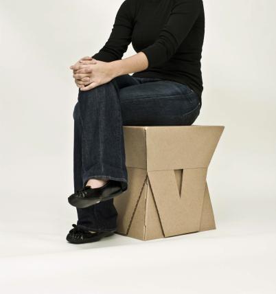 Student sitting on constructed stool 