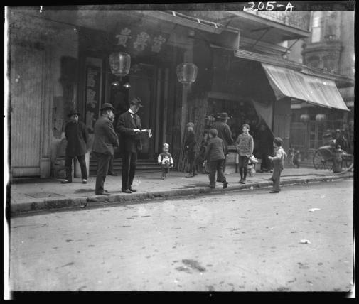 Children and men on a street in San Francisco's Chinatown