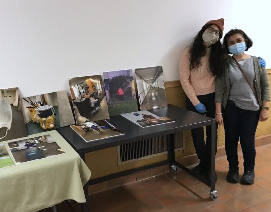 Evalynn Romano and her mother Evalina Romano next to tables with photographs