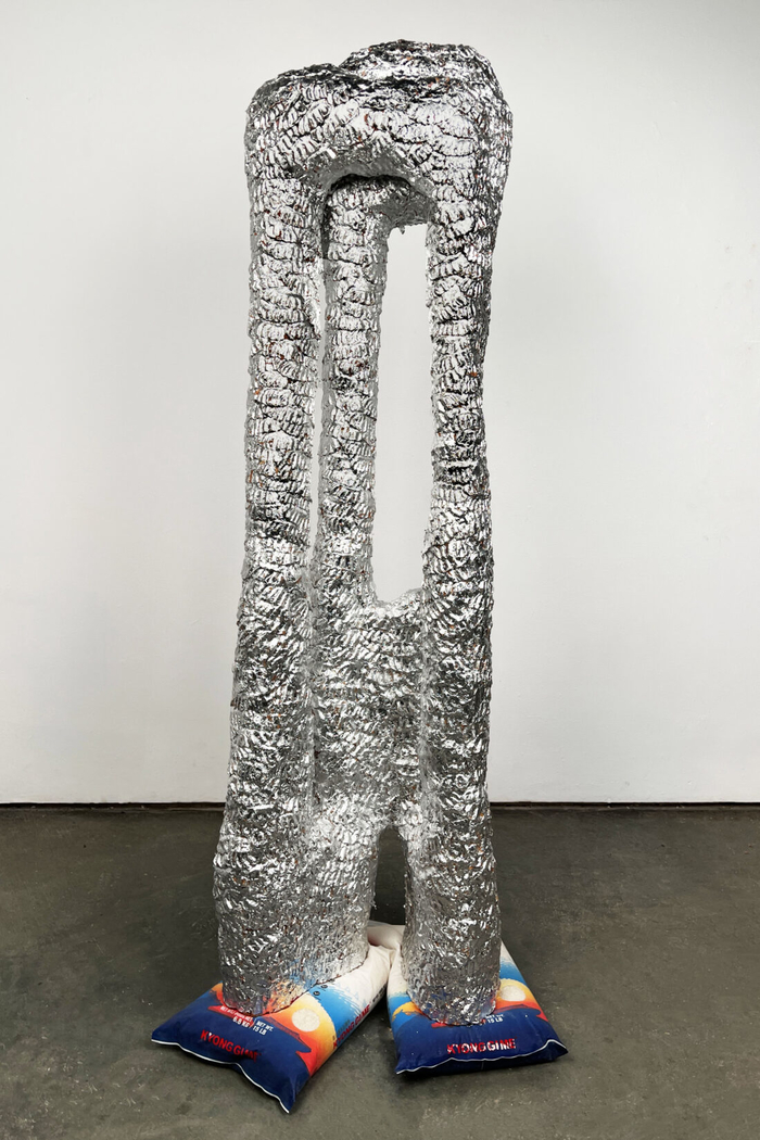 Michael Hong. 큰 손 (Big-Hand), 2024. Stoneware, aluminum silver leaf, and rice bags. 72 x 24 x 24 inches