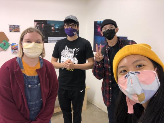 Four students wearing masks in a gallery setting