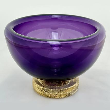 purple bowl made of blown glass, with a gold-flecked base