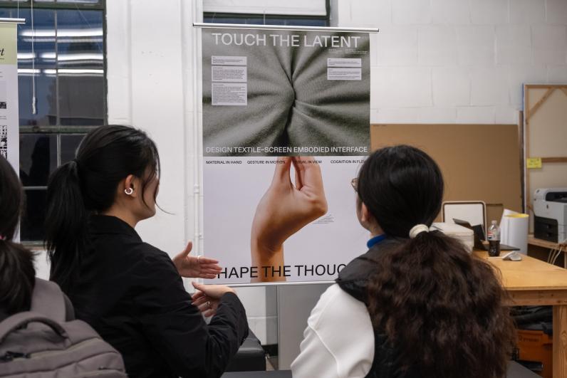People viewing a Master of Design graduate student's work.