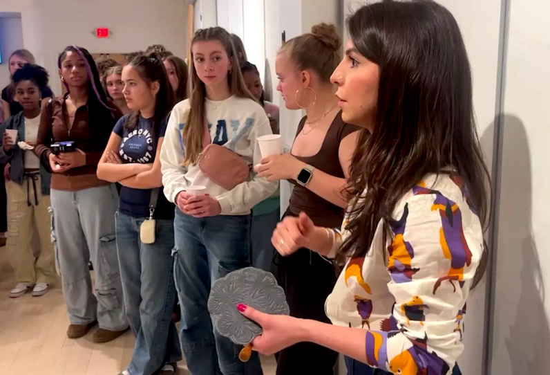 Christie Tirado explaining the process of creating relief block prints to students.