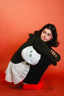 Design student posing with a ReMade bag from the Air collection