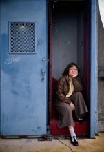 Close-up of Alum Vivian Cho sitting on the University Bridge