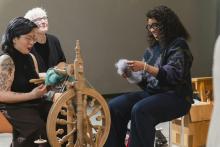 Indira and visitors weaving at exhibition opening