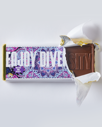Partially open chocolate bar, wrapper reads "enjoy diversity, now with more diversity"