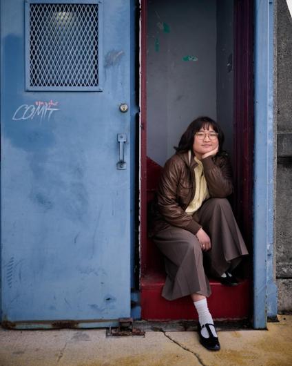 Close-up of Alum Vivian Cho sitting on the University Bridge