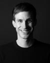 Black and White portrait of person wearing black t-shirt on a dark background