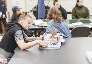 Veronica Markey looking at pop-up artist books in the UW Special Collections Library