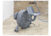 Grey industrial sculpture with seat by Dozie Kanu