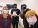 Four students wearing masks in a gallery setting