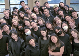 Group of people wearing black with heads all tilted to the side
