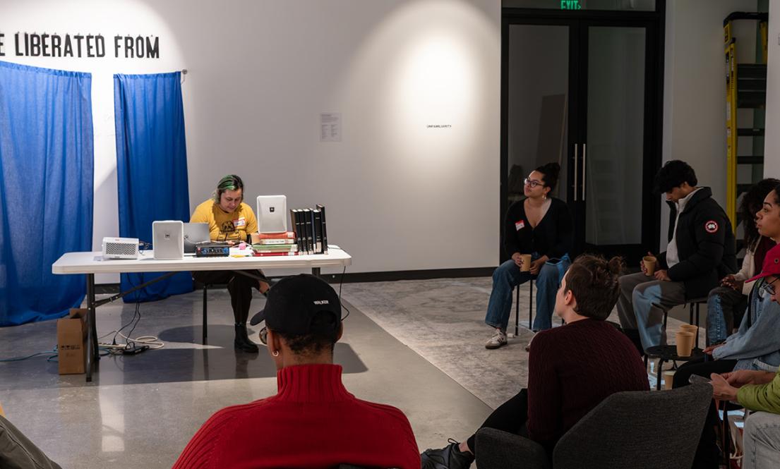 Chave Pichardo faciliutating a book club session in the Jacob Lawrence Gallery