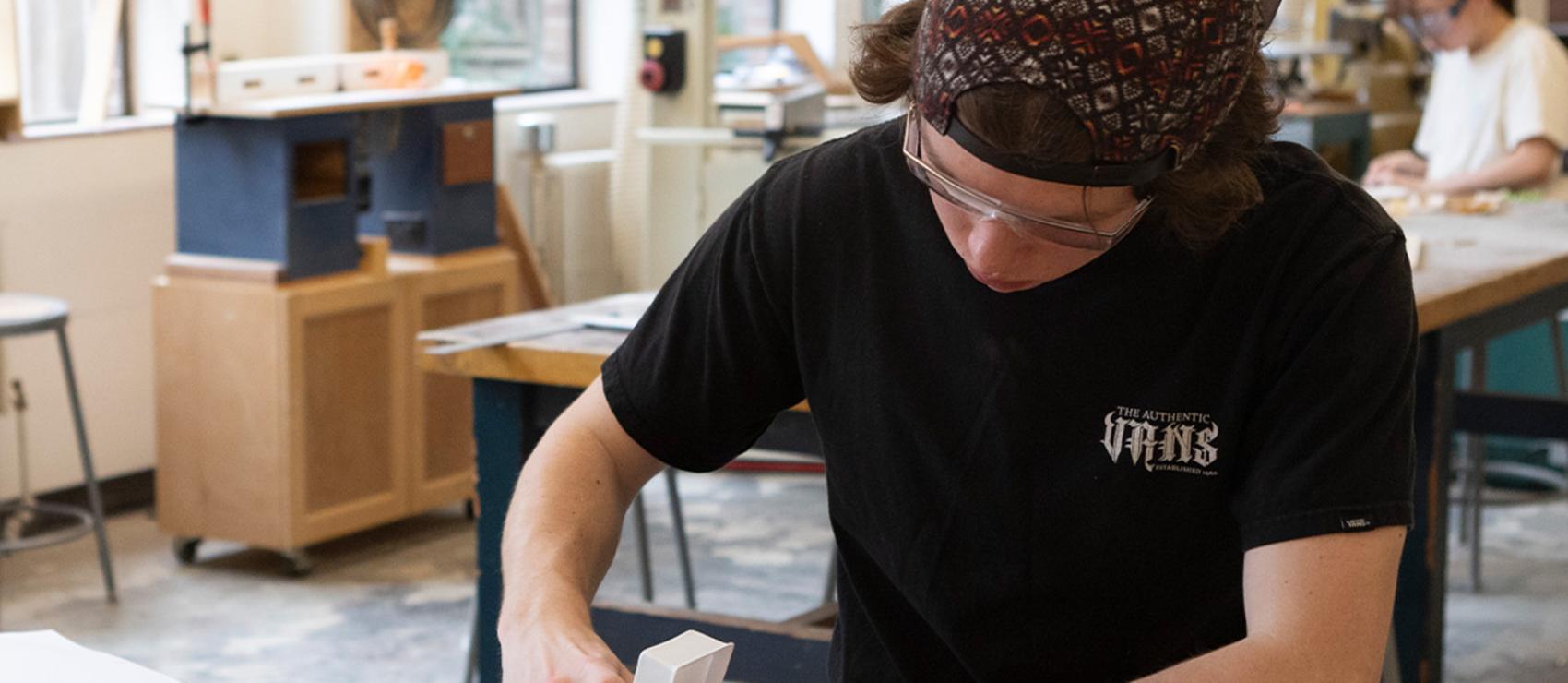 Design student creating a prototype  in the woodshop