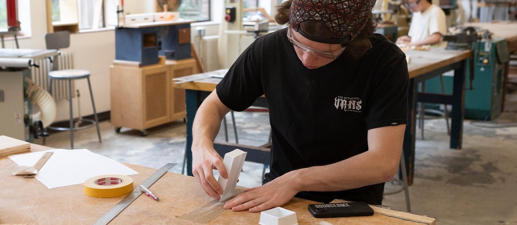 Design student creating a prototype  in the woodshop