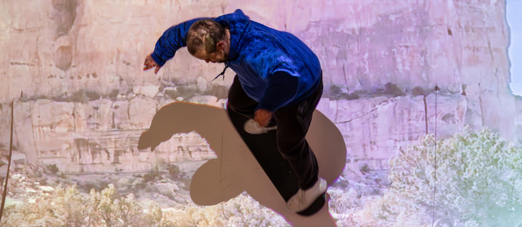 Participant skateboarding on student's interactive installation