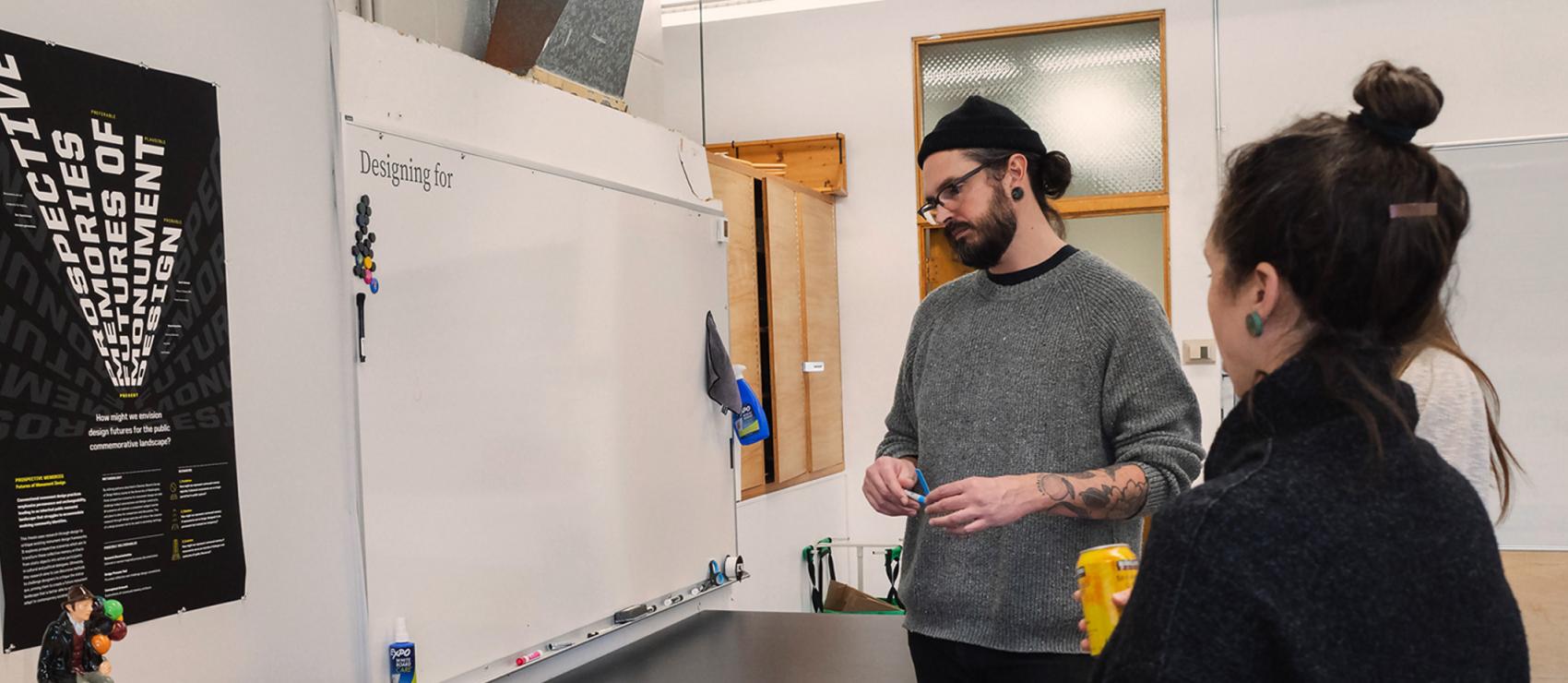 People viewing a Master of Design graduate student's work.