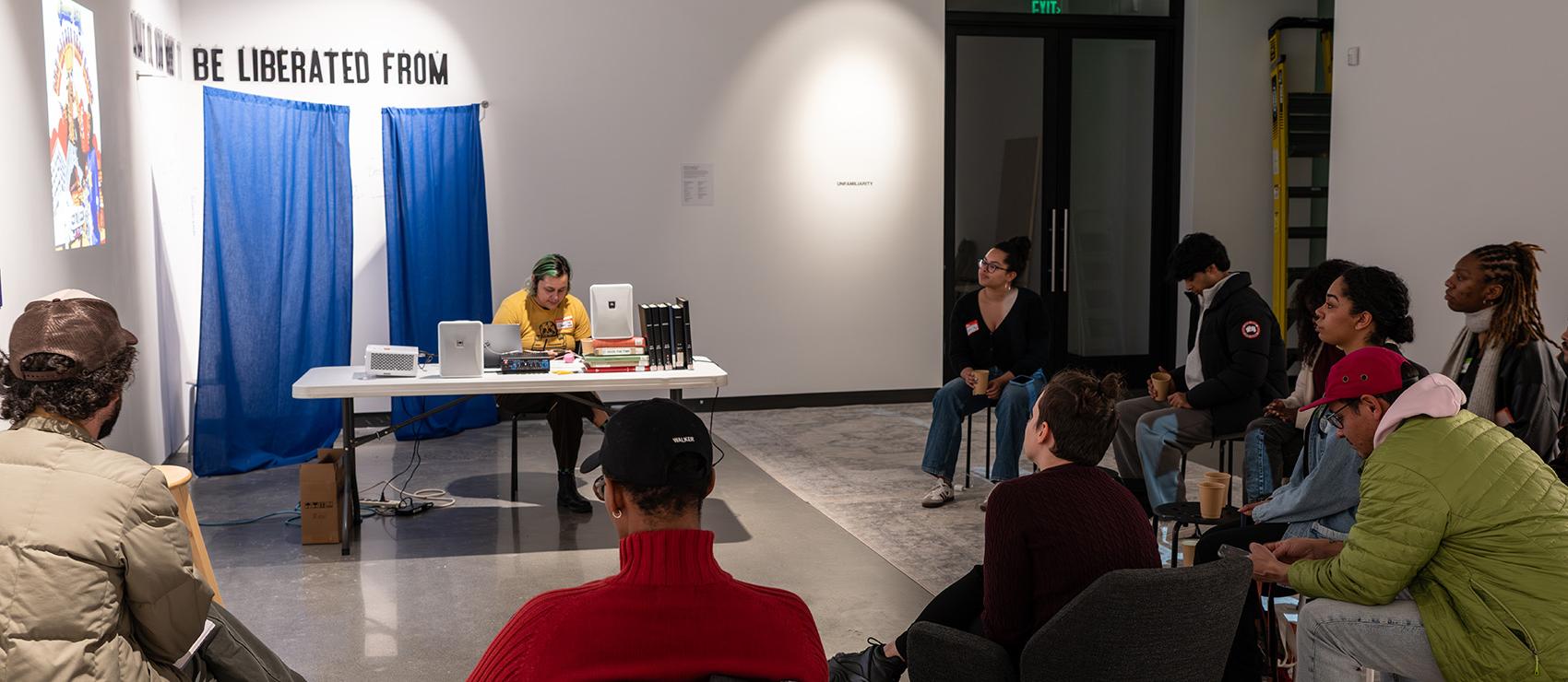 Chave Pichardo faciliutating a book club session in the Jacob Lawrence Gallery