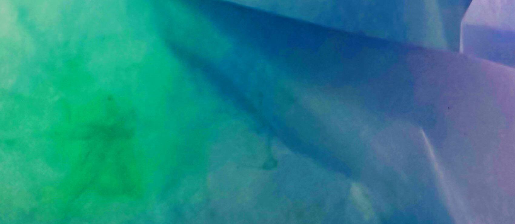 Abstract art with regions of blue, green, and violet merging into one another