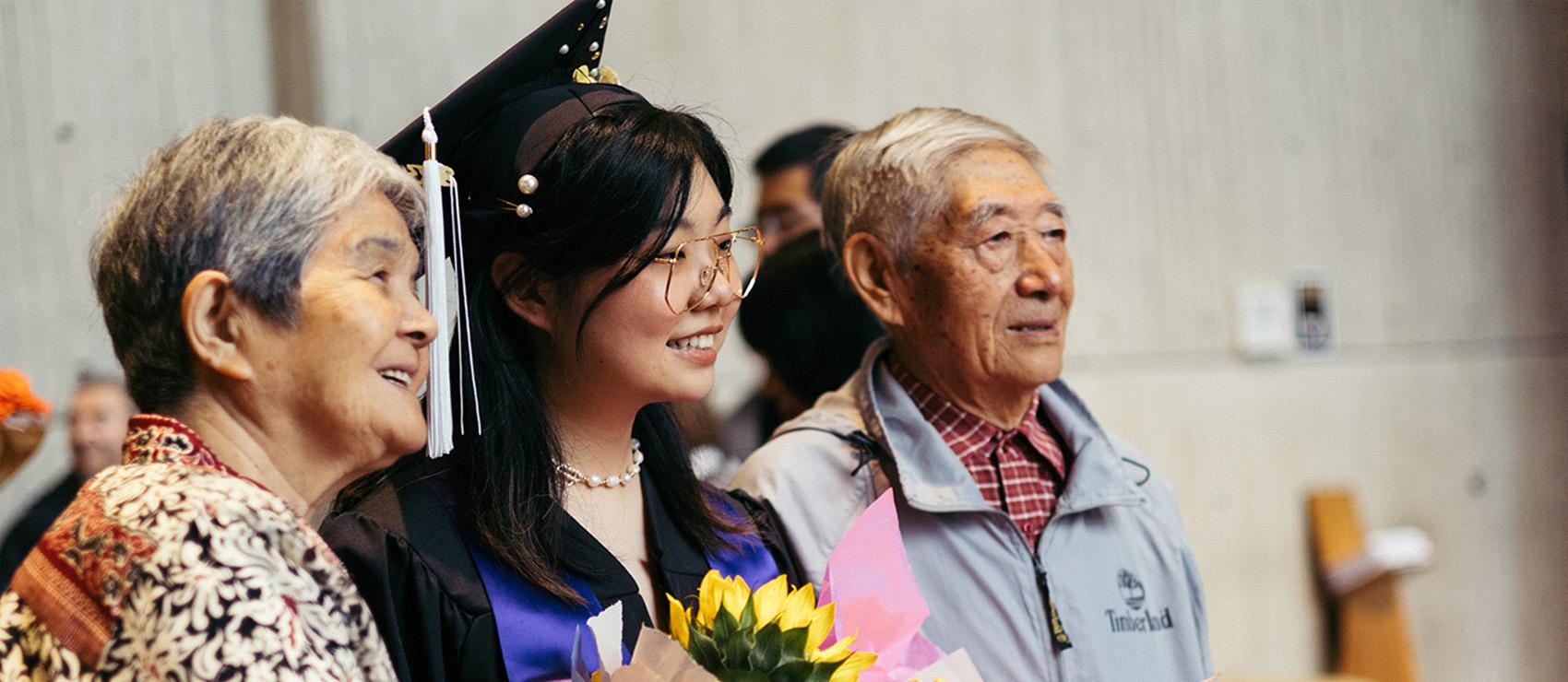 Student with family at the graduation celebration