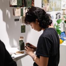 A visitor engaging with the student work on display.
