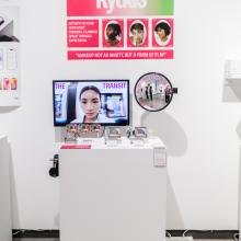 Exhibition view with hanging poster and display table.
