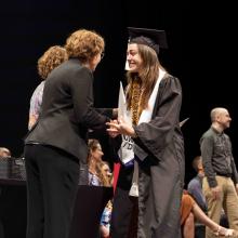 Graduate accepting diploma on the stage