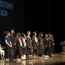 Graduates standing together on the stage