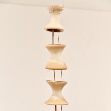 Close-up of student's glasswork suspended on pedestal