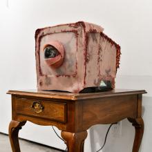 Close-up of student's glasswork on a small wooden table