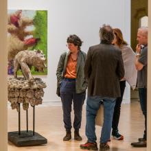 Visitors viewing sculptural work at exhibition