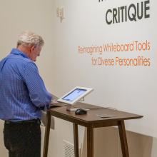 Visitor interacting with student's work