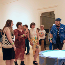 Exhibition view of attendees interacting with a graduate's work