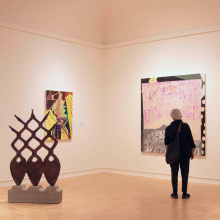 Exhibition view of an attendee viewing a graduate's work on the wall