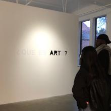 art students looking at work in a gallery