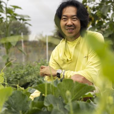 Rob Rhee tending to his gourds at UW Farm