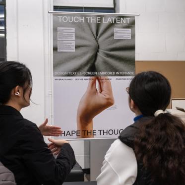 People viewing a Master of Design graduate student's work.