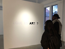 art students looking at work in a gallery