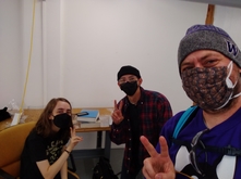 Three students wearing face masks in a studio setting